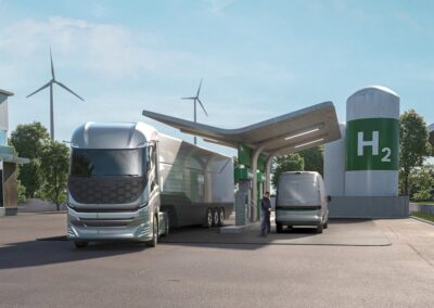 Wertschöpfungskette für Wasserstoff in Europa wird konkret Eine Computergrafik, die einen Sattelzug und einen Transporter an einer zukünftigen Wasserstofftankstelle zeigt