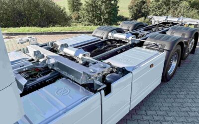 Blick auf das Fahrgestell eines batterieelektrischen Dreiachsers vom Typ DAF XG 350 Electric FAN 6x2 mit Fokus auf die seitlich montierten Batteriepakete und die Twistlocks des BDF-Aufbaus