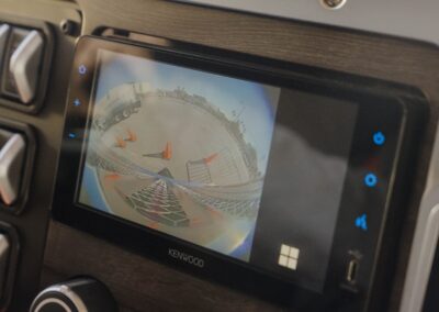 Blick auf das Touchscreen-Sekundärdisplay in einem US-amerikanischen Hauben-Lkw von Daimler Truck; auf dem Monitor wird eine 360-Grad-Sicht um das Fahrzeug angezeigt