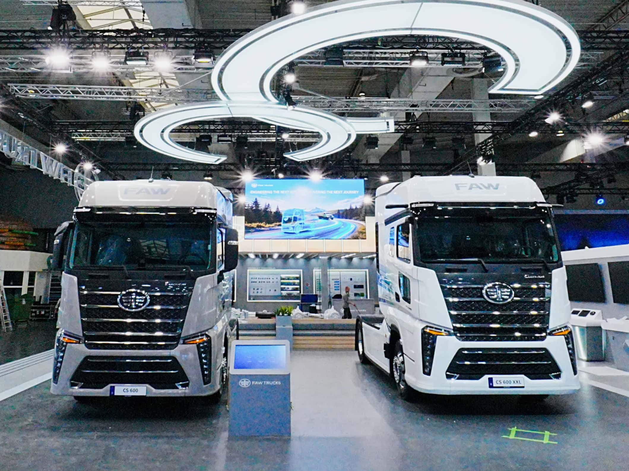 Zwei Sattelzugmaschinen vom Typ FAW Cortron CS600 und CS600 XXL (rechts) nebeneinander auf einem Messestand