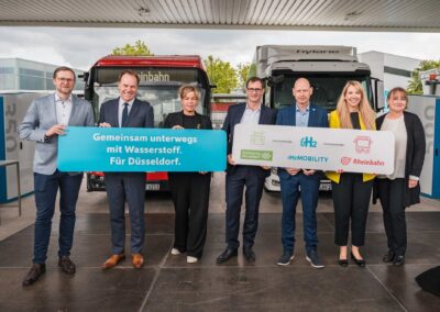 H2-Tankstelleneröffnung in Düsseldorf mit Aufstellung von sieben Personen aus Politik und Wirtschaft